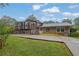 Home exterior featuring a deck, sunroom, and lush green surroundings providing privacy at 4457 Huntshire Dr, Stone Mountain, GA 30083