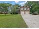 Traditional two-story house featuring a well-maintained lawn and double garage doors at 4457 Huntshire Dr, Stone Mountain, GA 30083