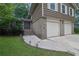 Charming home exterior with a brick facade, two-car garage, and well-maintained lawn at 4457 Huntshire Dr, Stone Mountain, GA 30083