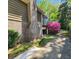 Exterior view with a brick chimney and beautiful landscaping at 4457 Huntshire Dr, Stone Mountain, GA 30083