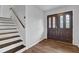 Bright foyer featuring hardwood floors, stairs, and a beautifully designed front door at 4457 Huntshire Dr, Stone Mountain, GA 30083