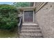 Inviting front entrance featuring brick steps and a double door entry at 4457 Huntshire Dr, Stone Mountain, GA 30083