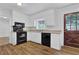 Charming kitchen featuring modern black appliances, white cabinets, and a farmhouse-style door at 4457 Huntshire Dr, Stone Mountain, GA 30083