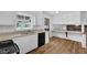 Bright kitchen with white cabinets, modern appliances, and breakfast bar with a view to the Gathering room at 4457 Huntshire Dr, Stone Mountain, GA 30083
