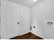 Clean laundry room with white walls, wood flooring, and utility connections at 4457 Huntshire Dr, Stone Mountain, GA 30083