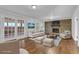Spacious living room with a cozy brick fireplace and access to an outdoor patio at 4457 Huntshire Dr, Stone Mountain, GA 30083
