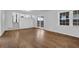 Bright living room with wood flooring, French doors, and multiple windows for natural light at 4457 Huntshire Dr, Stone Mountain, GA 30083