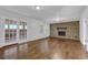 Spacious living room with wood floors, a brick fireplace, and French doors leading to sunroom at 4457 Huntshire Dr, Stone Mountain, GA 30083