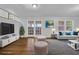 Modern living room with hardwood flooring, french doors, and ample natural light at 4457 Huntshire Dr, Stone Mountain, GA 30083