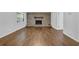 Spacious living room with a cozy brick fireplace and hardwood floors at 4457 Huntshire Dr, Stone Mountain, GA 30083