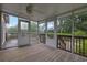 Enclosed sunroom featuring a ceiling fan and sliding glass doors to enjoy outdoor views in comfort at 4457 Huntshire Dr, Stone Mountain, GA 30083