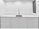 Basement area features a white cabinet with a marble countertop and modern faucet and sink at 11 Ardmore Nw Sq, Atlanta, GA 30309