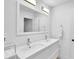 Bright bathroom featuring double sinks, contemporary fixtures, and a large mirror at 11 Ardmore Nw Sq, Atlanta, GA 30309