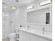 Clean, all white bathroom featuring double vanity, large mirror, and a glass-enclosed shower at 11 Ardmore Nw Sq, Atlanta, GA 30309