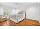 Cozy bedroom featuring hardwood floors, a comfortable chair, and a window with natural light at 11 Ardmore Nw Sq, Atlanta, GA 30309