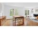 Bright dining room with hardwood floors, large windows, modern chairs, and a view of the living room at 11 Ardmore Nw Sq, Atlanta, GA 30309