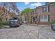 Charming brick townhome featuring a well-maintained front yard and driveway parking at 11 Ardmore Nw Sq, Atlanta, GA 30309