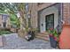 Inviting brick home entrance featuring a stone walkway, potted plants, and a decorative wrought iron porch at 11 Ardmore Nw Sq, Atlanta, GA 30309