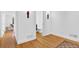 Bright hallway with hardwood floors leading to a bathroom and a living area at 11 Ardmore Nw Sq, Atlanta, GA 30309