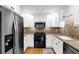 Well-lit kitchen with granite countertops, white cabinets, stainless steel appliances, and hardwood floors at 11 Ardmore Nw Sq, Atlanta, GA 30309