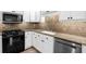 Kitchen with granite countertops, stainless steel appliances, white cabinets, and hardwood floors at 11 Ardmore Nw Sq, Atlanta, GA 30309