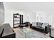 Bright living room features a black leather sofa and chair with modern decor and glass coffee table at 11 Ardmore Nw Sq, Atlanta, GA 30309