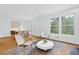 Bright living room with hardwood floors, modern chairs, table, and large windows for lots of natural light at 11 Ardmore Nw Sq, Atlanta, GA 30309