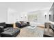 Bright living room with hardwood floors, large bay window, and comfortable leather seating arrangement at 11 Ardmore Nw Sq, Atlanta, GA 30309