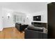 Bright and open living room featuring hardwood floors, a large TV, and comfortable leather seating at 11 Ardmore Nw Sq, Atlanta, GA 30309