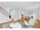 Open floor plan with staircase, modern chairs, table, and hardwood floors, with a view of kitchen at 11 Ardmore Nw Sq, Atlanta, GA 30309