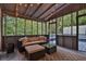 Relaxing screened porch featuring a comfortable seating area, string lights, and views of the surrounding greenery at 11 Ardmore Nw Sq, Atlanta, GA 30309