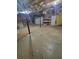 Unfinished basement shows storage shelving and door with exposed ceiling and insulation at 129 Carolyn Path, Rockmart, GA 30153