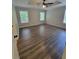 The main bedroom features hardwood floors, a tray ceiling, and large windows at 129 Carolyn Path, Rockmart, GA 30153