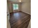 This bright bedroom is spacious and features wood flooring and a large window at 129 Carolyn Path, Rockmart, GA 30153