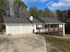 Exterior view of home with deck, garage and landscaping at 129 Carolyn Path, Rockmart, GA 30153