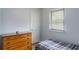 Inviting bedroom with a cozy bed, wooden dresser, and a window providing natural light at 2469 Silver King Dr, Grayson, GA 30017