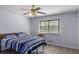 Comfortable bedroom featuring a ceiling fan and a large window overlooking a peaceful view at 2469 Silver King Dr, Grayson, GA 30017