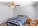 Serene bedroom with a blue striped comforter, a wicker chair and a window for ample natural light at 2469 Silver King Dr, Grayson, GA 30017