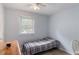 Relaxing bedroom with a comfortable bed, wooden dresser, and a bright window view at 2469 Silver King Dr, Grayson, GA 30017