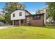 Charming two-story home with white siding, brick accents, a driveway, and an attached garage in a lush, green neighborhood at 2469 Silver King Dr, Grayson, GA 30017