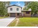Charming two-story home with white siding, brick accents, a driveway, and an attached garage in a lush, green neighborhood at 2469 Silver King Dr, Grayson, GA 30017