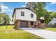 Charming two-story home with white siding, brick accents, a driveway, and an attached garage in a lush, green neighborhood at 2469 Silver King Dr, Grayson, GA 30017