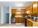 The kitchen features wood cabinets, stainless steel appliances, and luxury vinyl plank flooring at 2469 Silver King Dr, Grayson, GA 30017