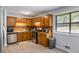 The kitchen features wood cabinets, stainless steel appliances, and luxury vinyl plank flooring at 2469 Silver King Dr, Grayson, GA 30017