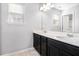 Bathroom showcasing double sinks with modern hardware and dark cabinets at 2769 Morgan Spring Trl, Buford, GA 30519