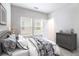 Cozy bedroom with patterned bedding, dresser and lots of natural light at 2769 Morgan Spring Trl, Buford, GA 30519