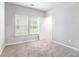 Empty bedroom with neutral walls, carpet, and natural light from two windows at 2769 Morgan Spring Trl, Buford, GA 30519