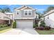 Charming two-story home with a two-car garage and gray siding, complemented by manicured landscaping at 2769 Morgan Spring Trl, Buford, GA 30519