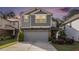 Charming two-story home with a two-car garage and gray siding, complemented by manicured landscaping at 2769 Morgan Spring Trl, Buford, GA 30519