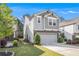 Charming two-story home with a two-car garage and gray siding, complemented by manicured landscaping at 2769 Morgan Spring Trl, Buford, GA 30519